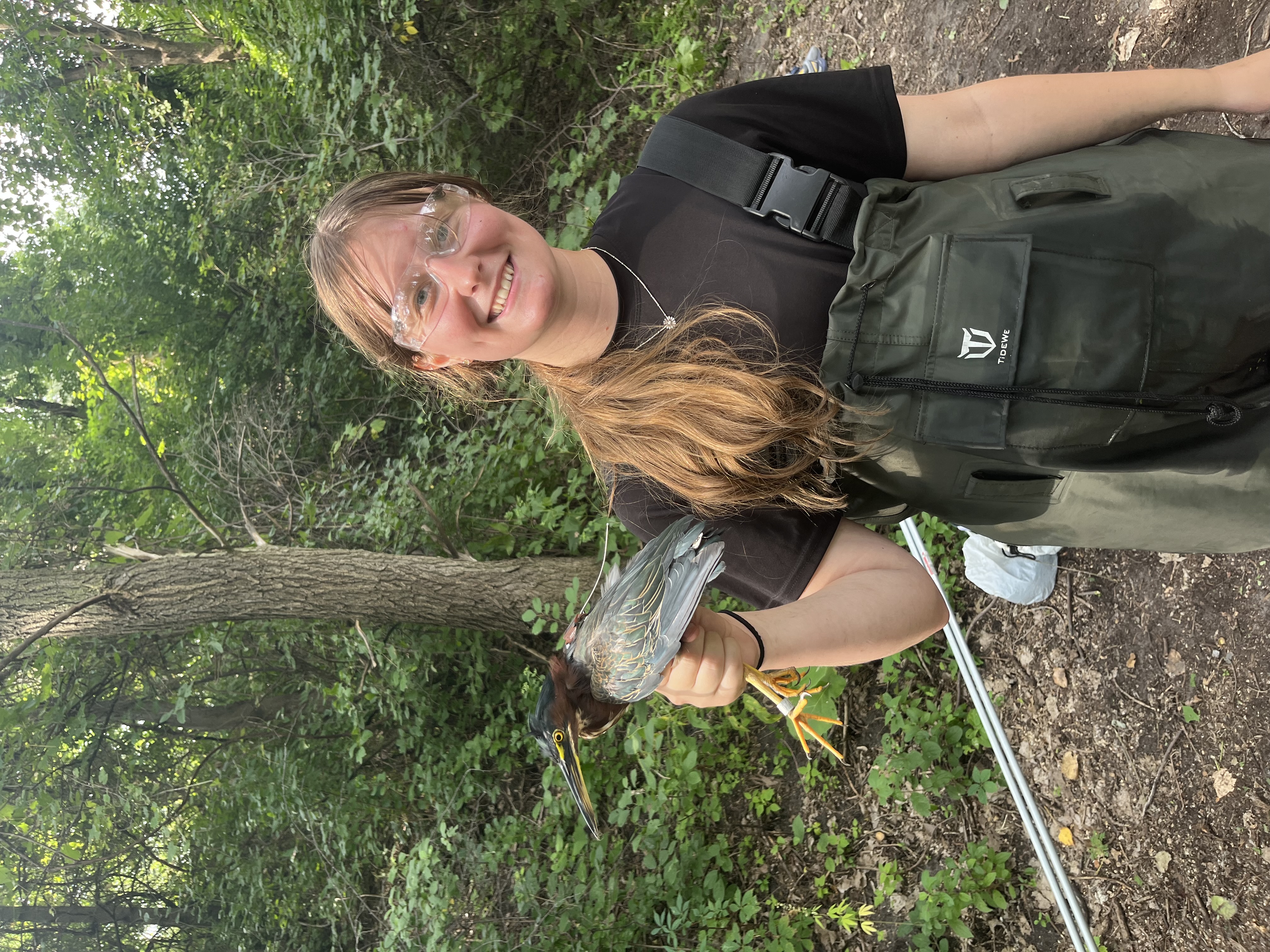 Hannah Slesinski holding a green heron